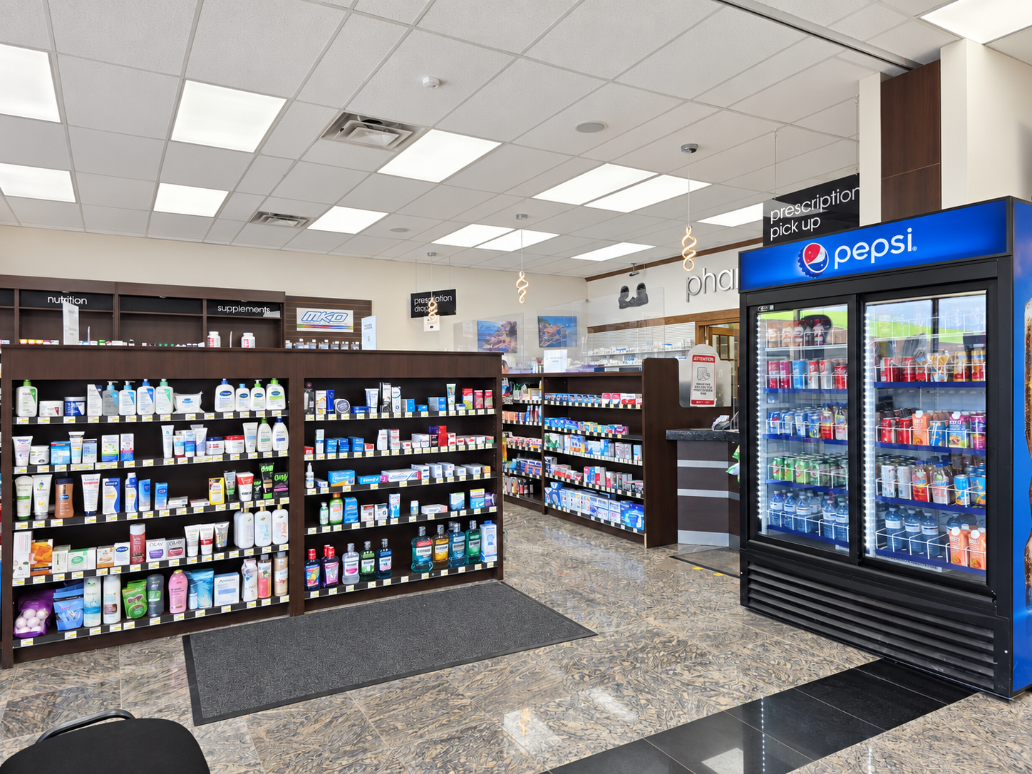 Inside Speedvale Pharmacy, with shelves of health products and the prescription counter